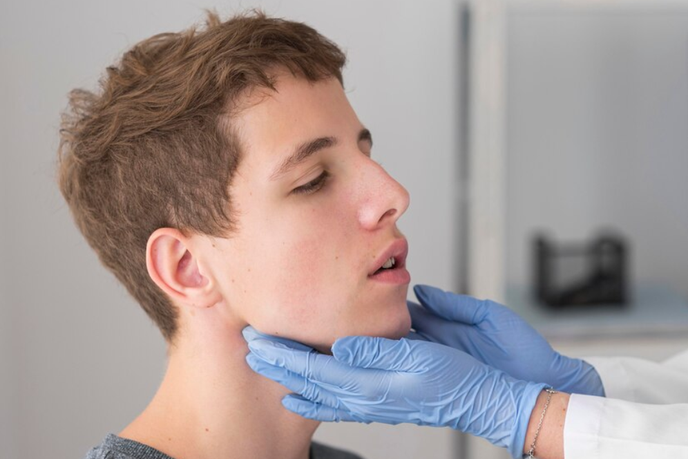 Jaw Misalignment male pediatrician doing vaccination to baby boy with a syringe in the hospital